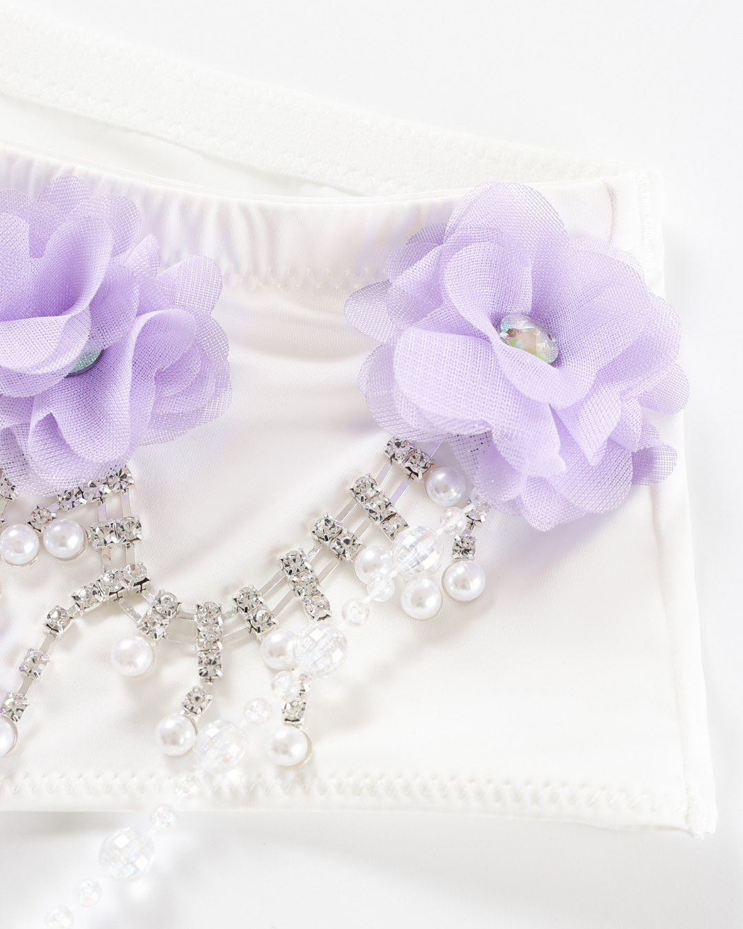 Lavendelle - Purple - Bottom features white fabric decorated with two light purple fabric flowers, clear beads, rhinestones, and pearl-like accents.