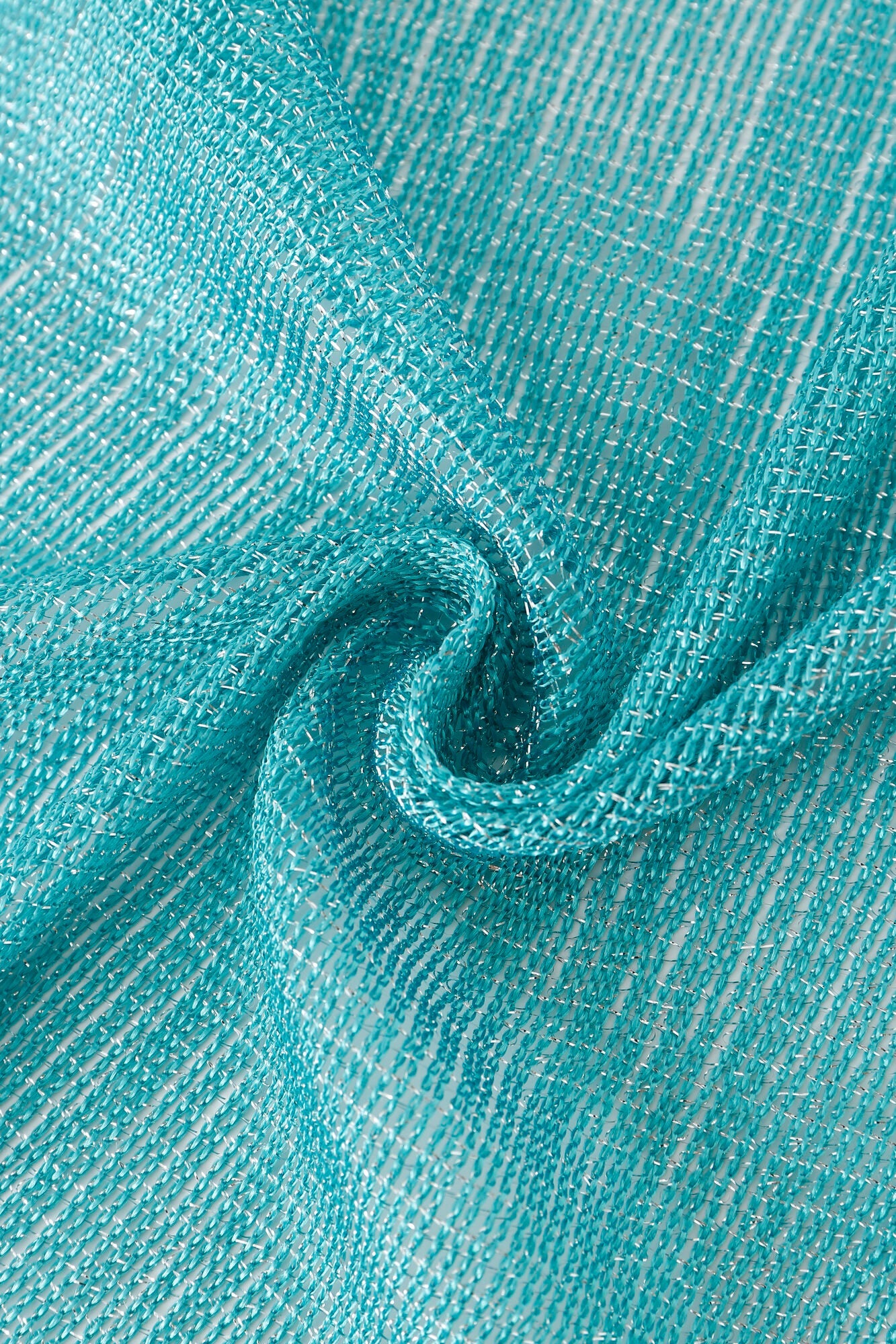Close-up of Pashmina - Aqua Solid Fringe fabric in textured turquoise with a subtle sheen, featuring a swirl pattern and visible woven threads.