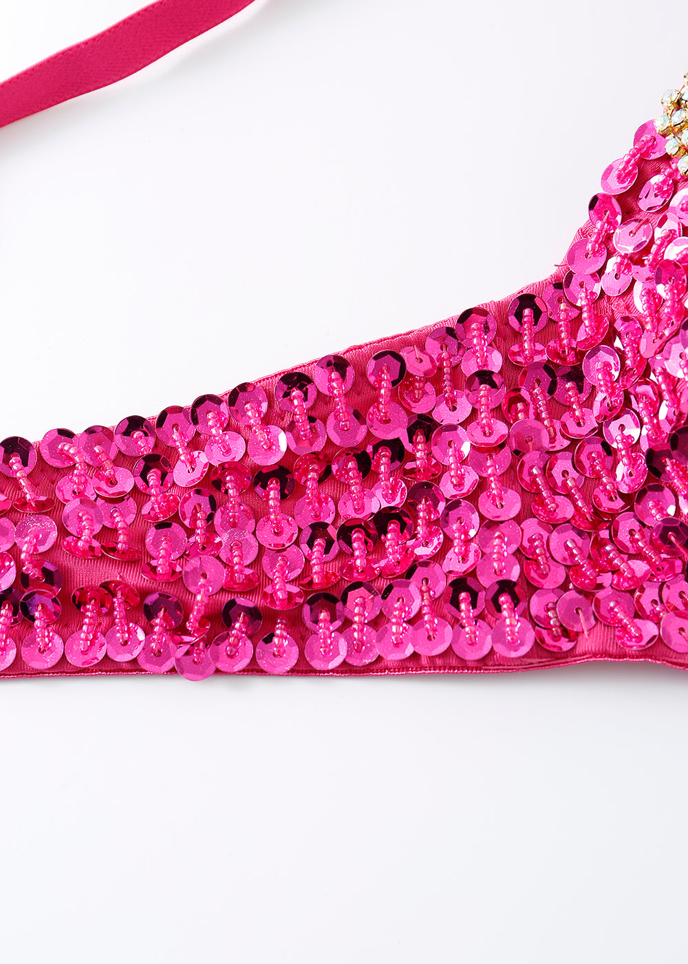 Close-up of the Vixen - Rosé - Bottom, featuring pink fabric and shiny pink sequins in overlapping rows, with a strap at the top left—ideal for festival wear or a sparkly rave outfit.