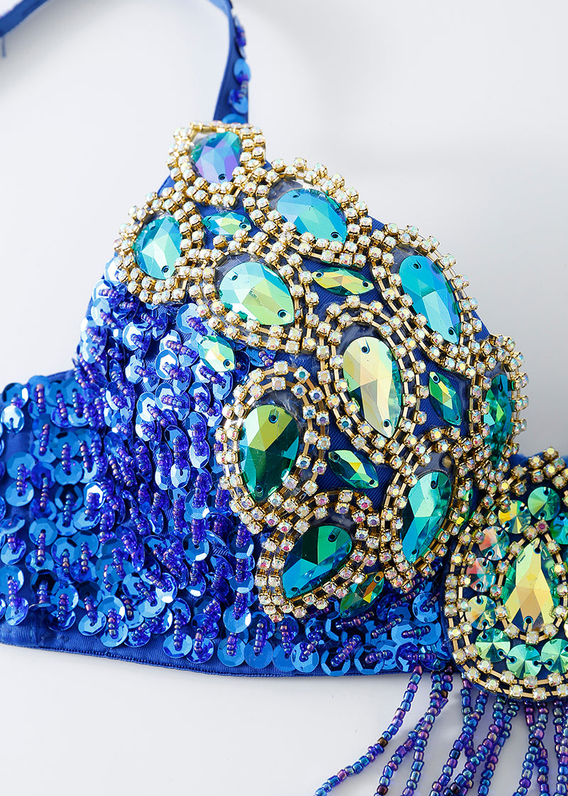A close-up of the Vixen - Royal Blue - Top, a rhinestone bra top ideal for raves or festivals, featuring large iridescent stones and gold beaded trim in a stylish design.