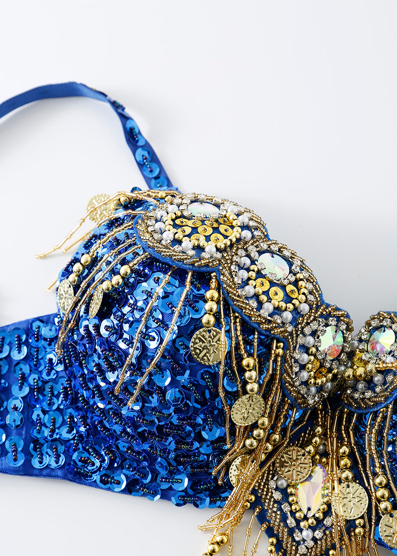 The Notics - Royal Blue - Top features blue sequins, crystal embellishments, gold coins, beads, reflective gems, and decorative chains—shown close-up on a white background. A perfect statement piece for your next rave or festival outfit.