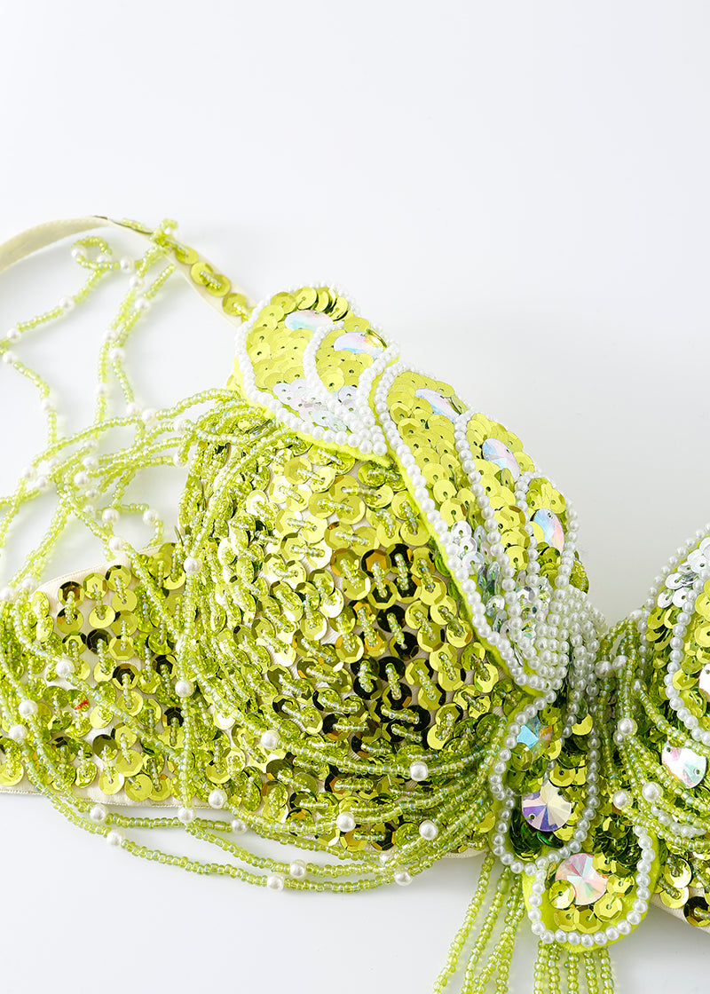 Close-up of the Venya - Lime Green - Top, a decorative sequin bra top embellished with beads and pearls—perfect for rave festivals—shown against a plain white background.