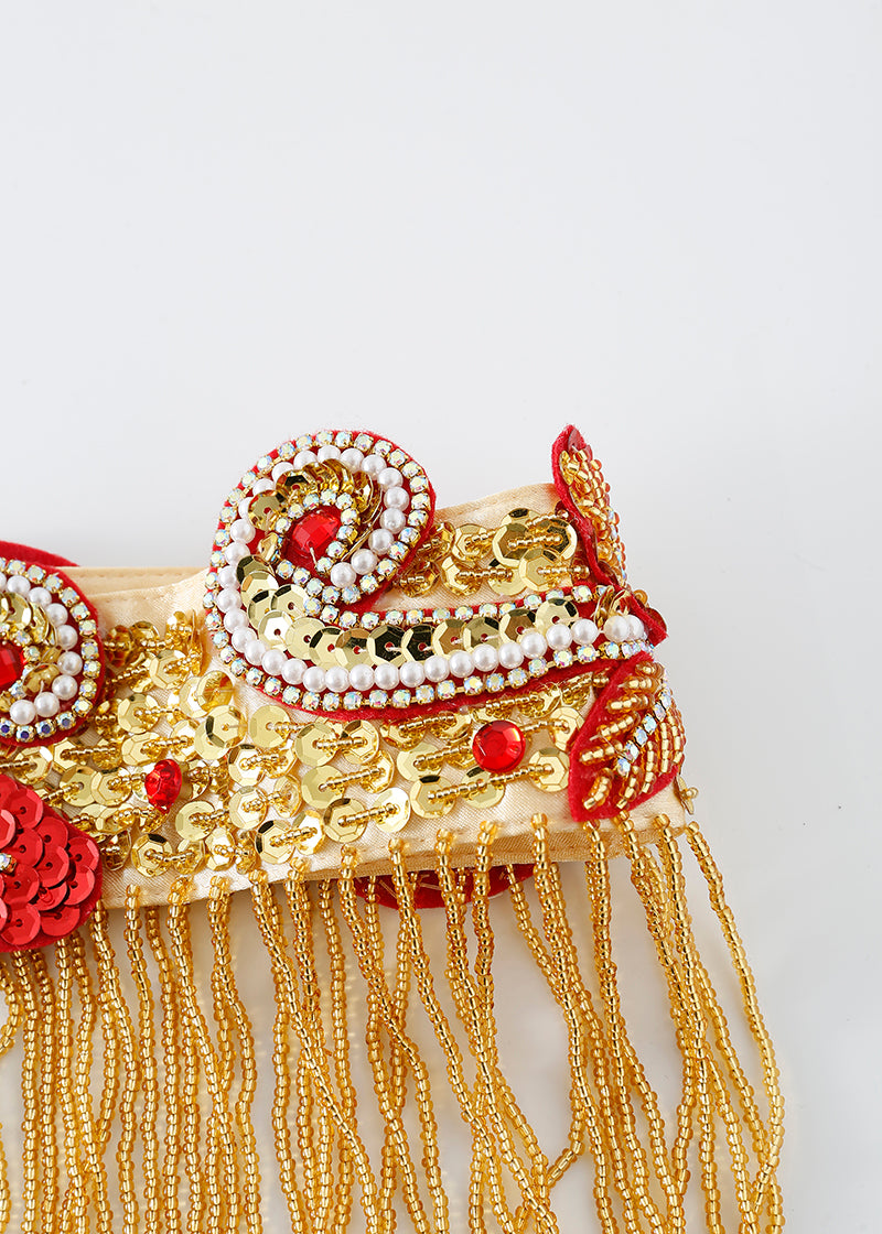 The Imperya - Gold - Bottom is a decorative gold and red embellished bottom with sequins, beads, and dangling gold chains, ideal for rave or festival wear, shown against a white background.