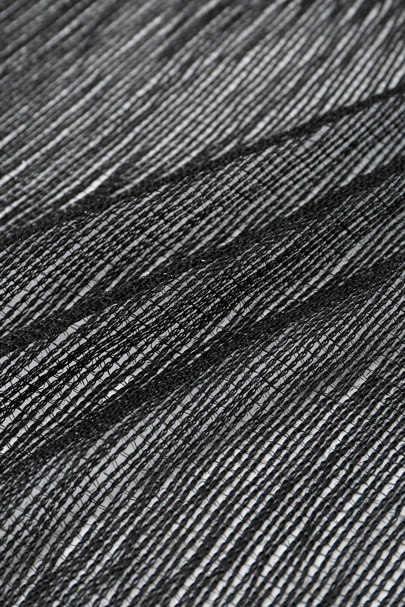 Close-up of Pashmina - Black Sheer Fringe, displaying fine, tightly spaced threads in a wavy, textured pattern across the horizontal mesh-like fabric.