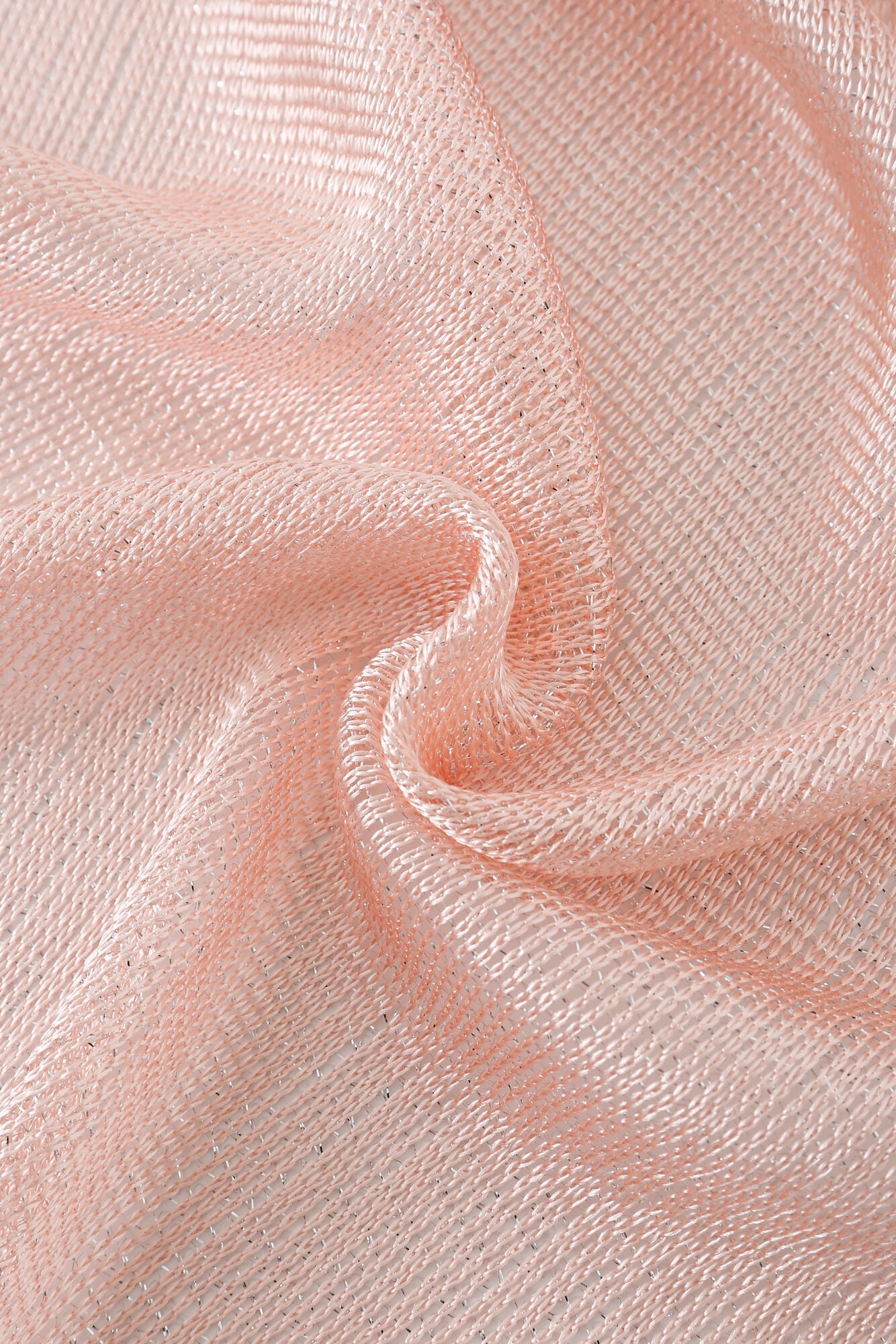 Close-up of the Pashmina - Blush Sheer Fringe, featuring draped, light pink textured mesh fabric woven with silver threads.