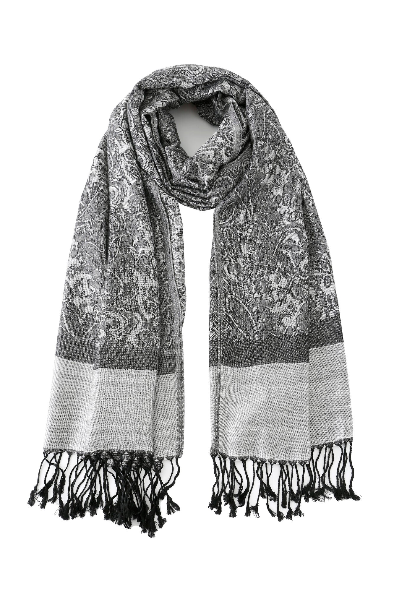 The Pashmina - Charcoal Bloom Fringe scarf features a gray paisley pattern, solid light gray borders, and black fringe tassels on both ends, displayed flat against a white background.