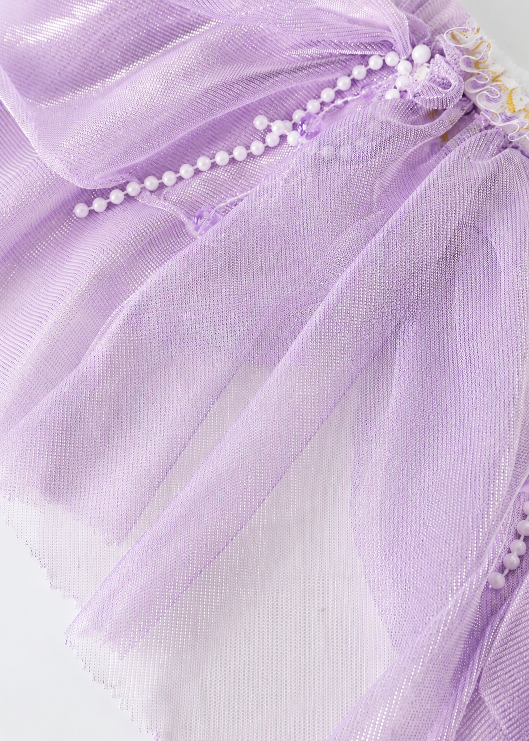 Crafted from sheer lavender fabric with elegant gathers, the Gossamer-Purple-Skirt features a delicate row of small white beads along the seam and is showcased against a simple background—making it an ideal choice for festival outfits or eye-catching rave wear.