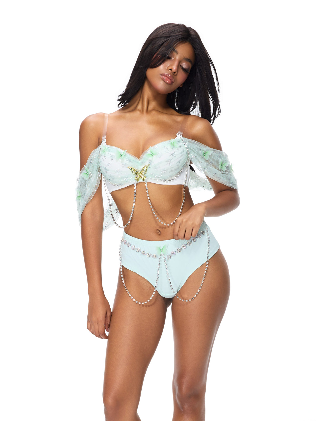 Woman wears Dream from the Sky- Full Set- Green featuring sheer off-shoulder sleeves, pearl chains, and butterflies—ideal festival wear against a white background.