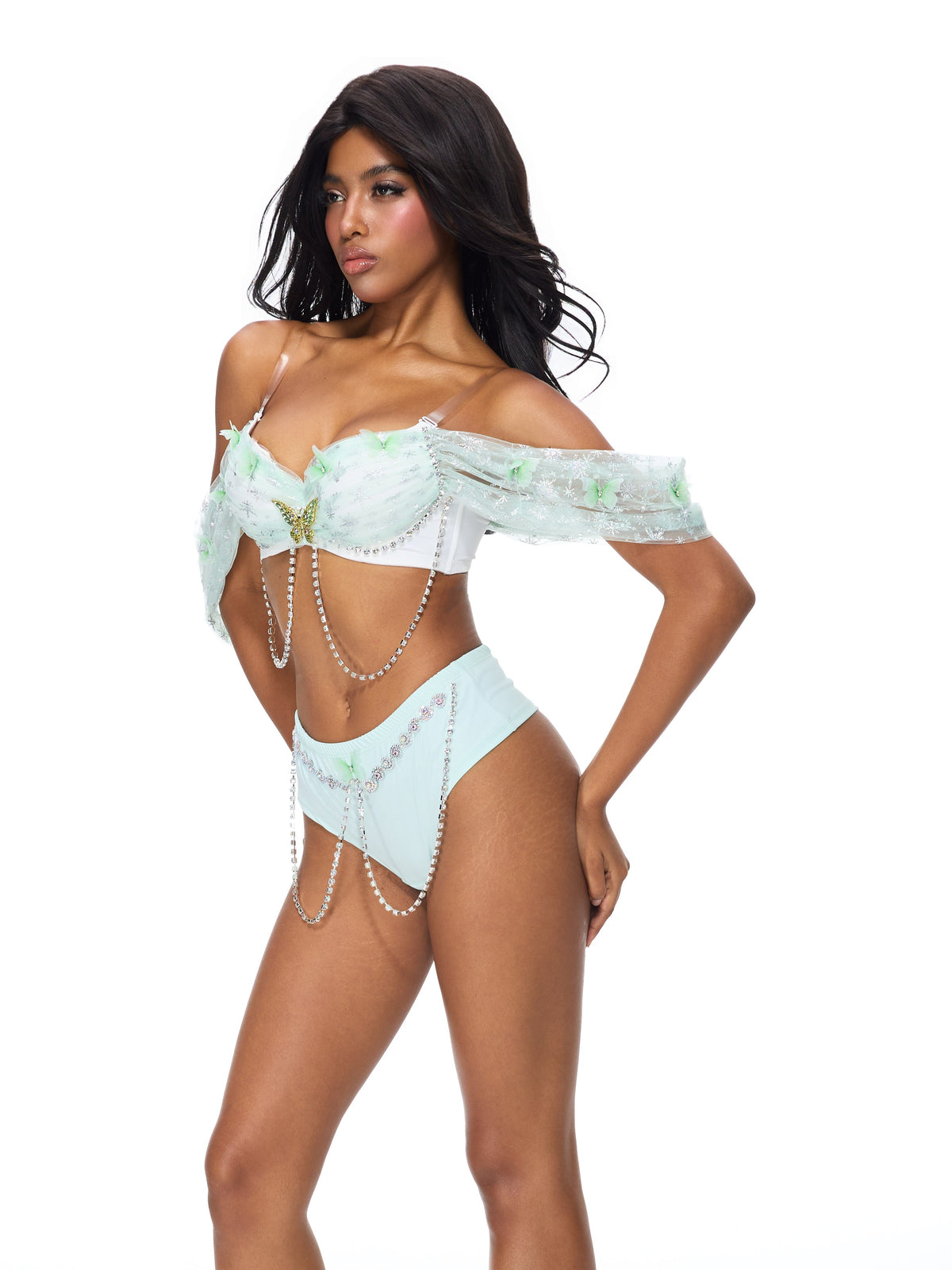 Model wears the Dream from the Sky- Full Set- Green, a light blue glitter push-up bra with decorative chains and green accents, perfect for raves or festivals.