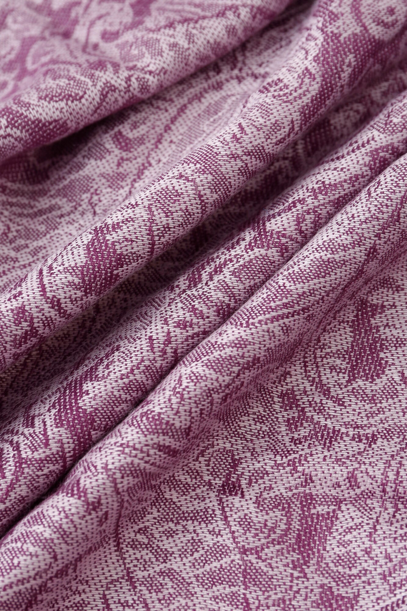 Close-up of folded Pashmina - Purple Paisley Fringe, featuring a detailed and intricate pink and white floral pattern.