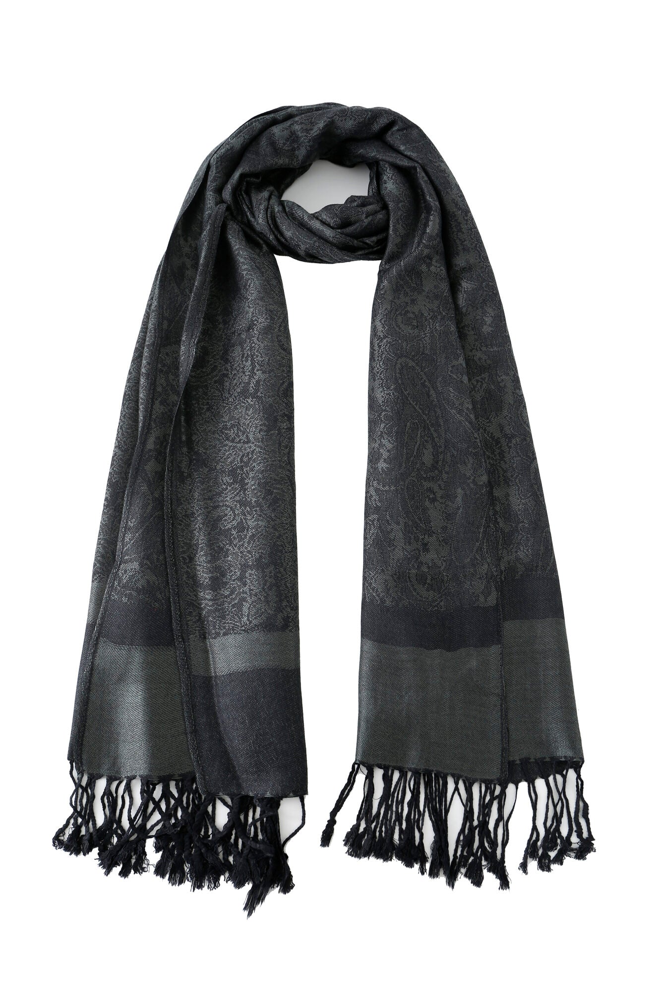 The Pashmina - Slate Paisley Fringe scarf features a dark gray hue, subtle paisley pattern, glossy finish, and fringed ends, shown against a plain white background.