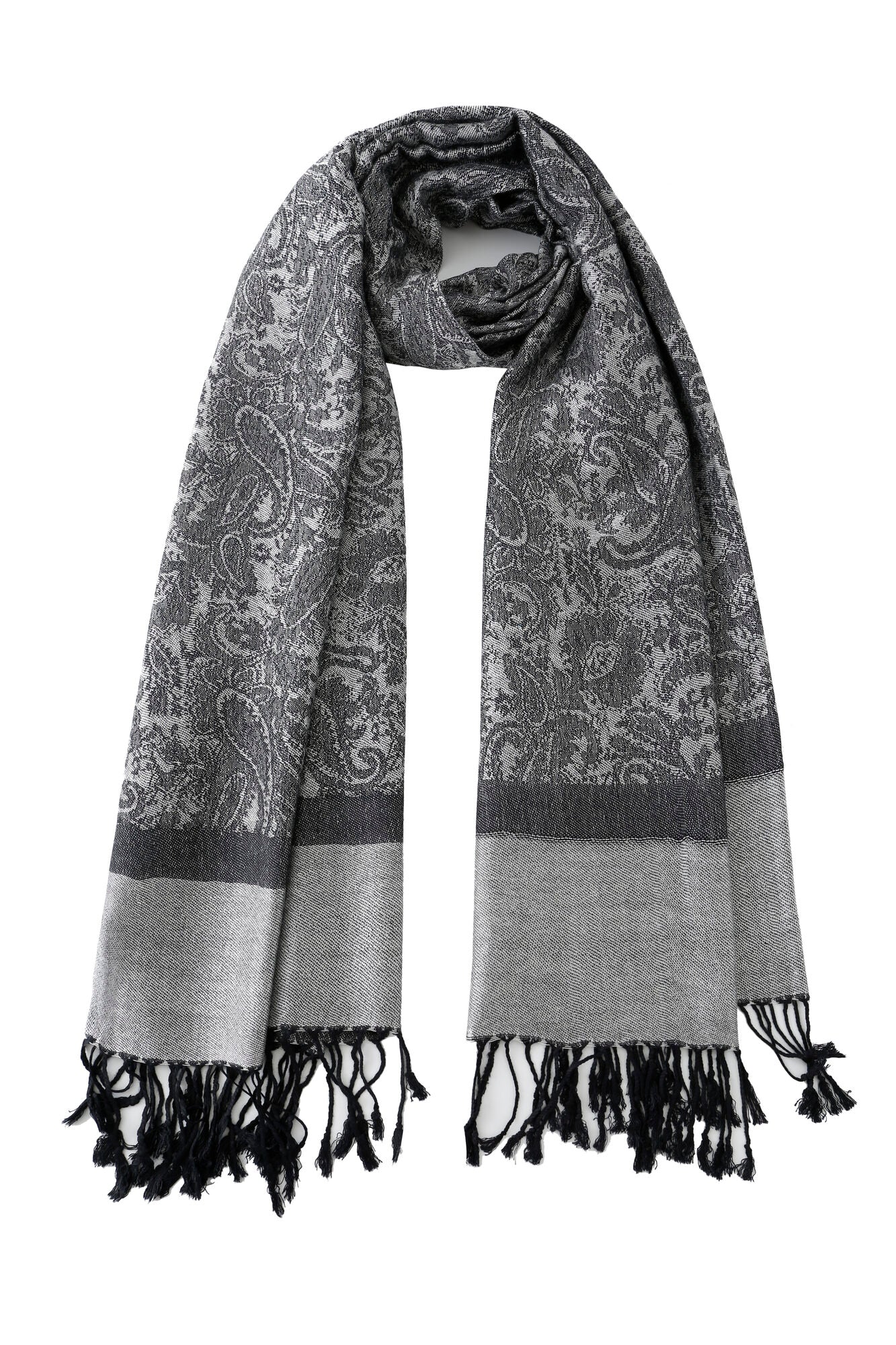 The Pashmina - Smoky Paisley Fringe scarf features a gray paisley design with black decorative borders and black fringe at both ends, shown laid flat on a white background.
