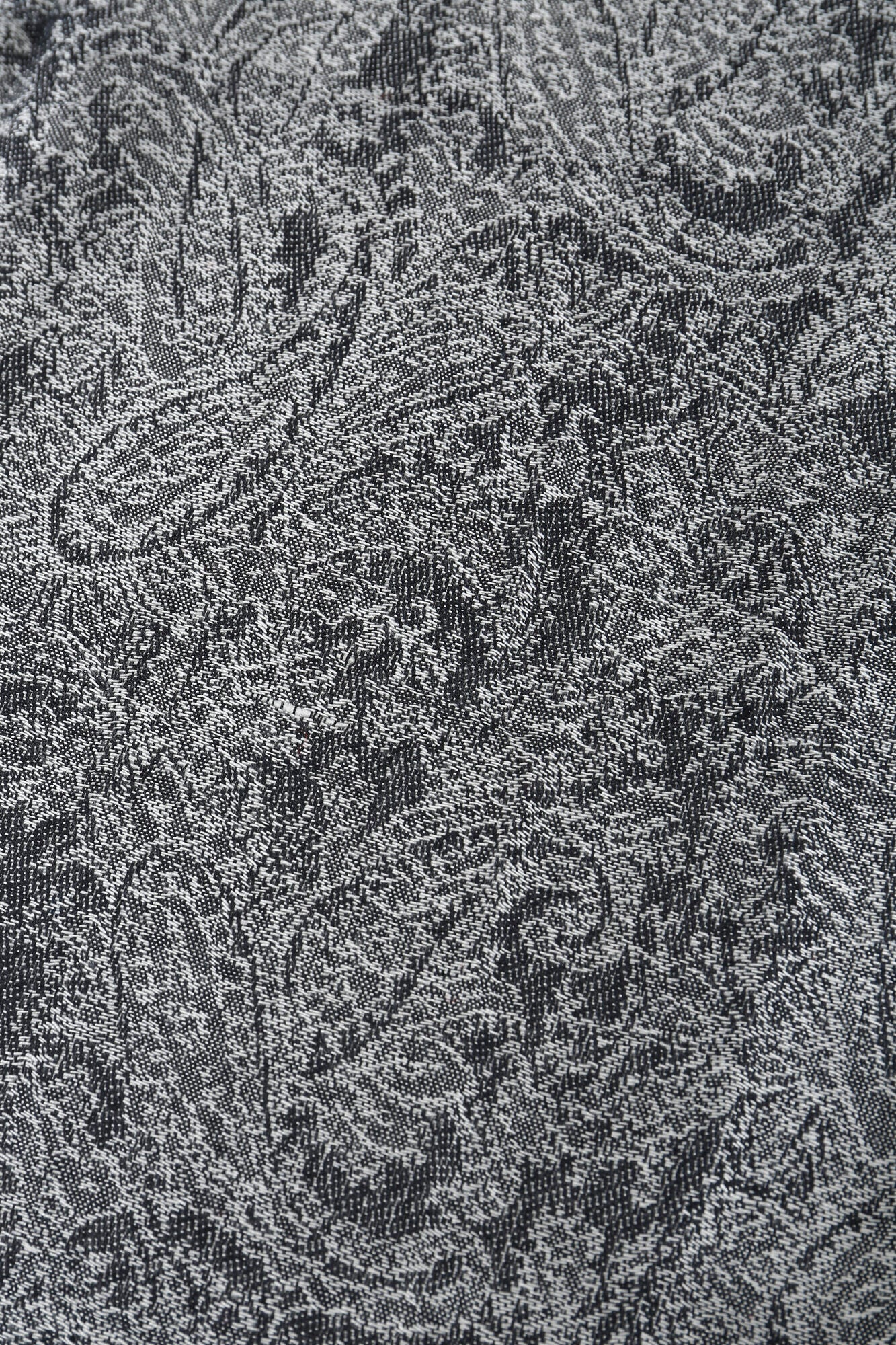 Close-up of the Pashmina - Smoky Paisley Fringe, featuring a detailed paisley pattern in gray and black tones.