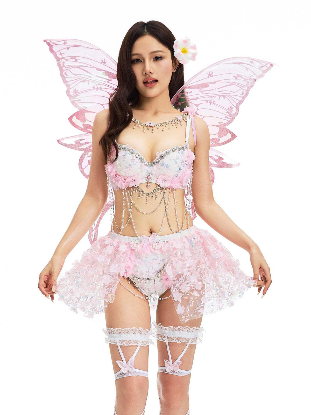 Dressed in The Fae- Lavendelle Pink butterfly fairy costume—with delicate wings, a flower in their hair, and lace accessories—a person poses against a white background, highlighting the enchanting butterfly thigh-high stockings that complete the look.