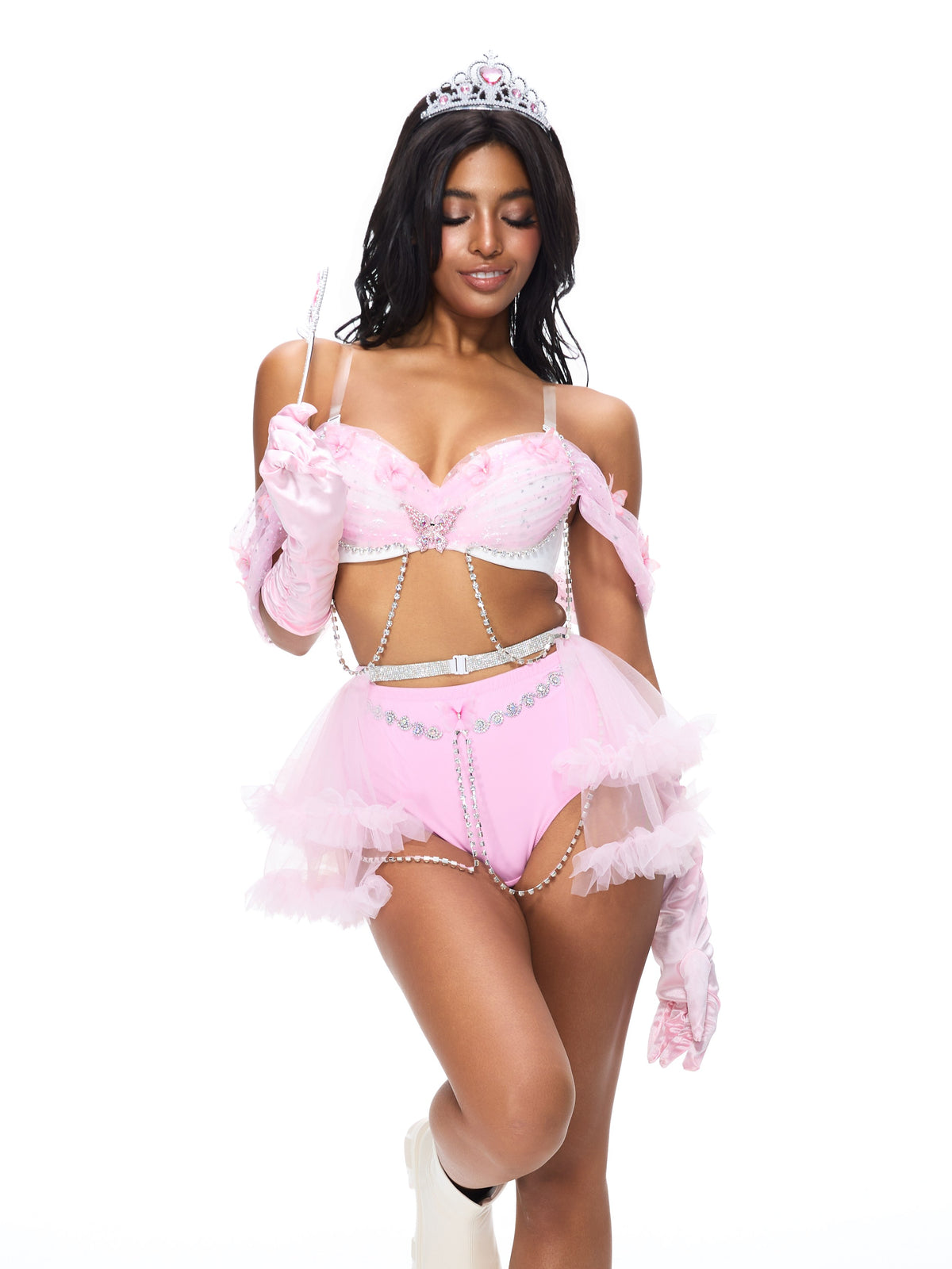 A woman dressed in the Princess 2 Pieces Set- Pink, featuring a pink princess costume complete with tiara, gloves, and wand, stands against a white background.