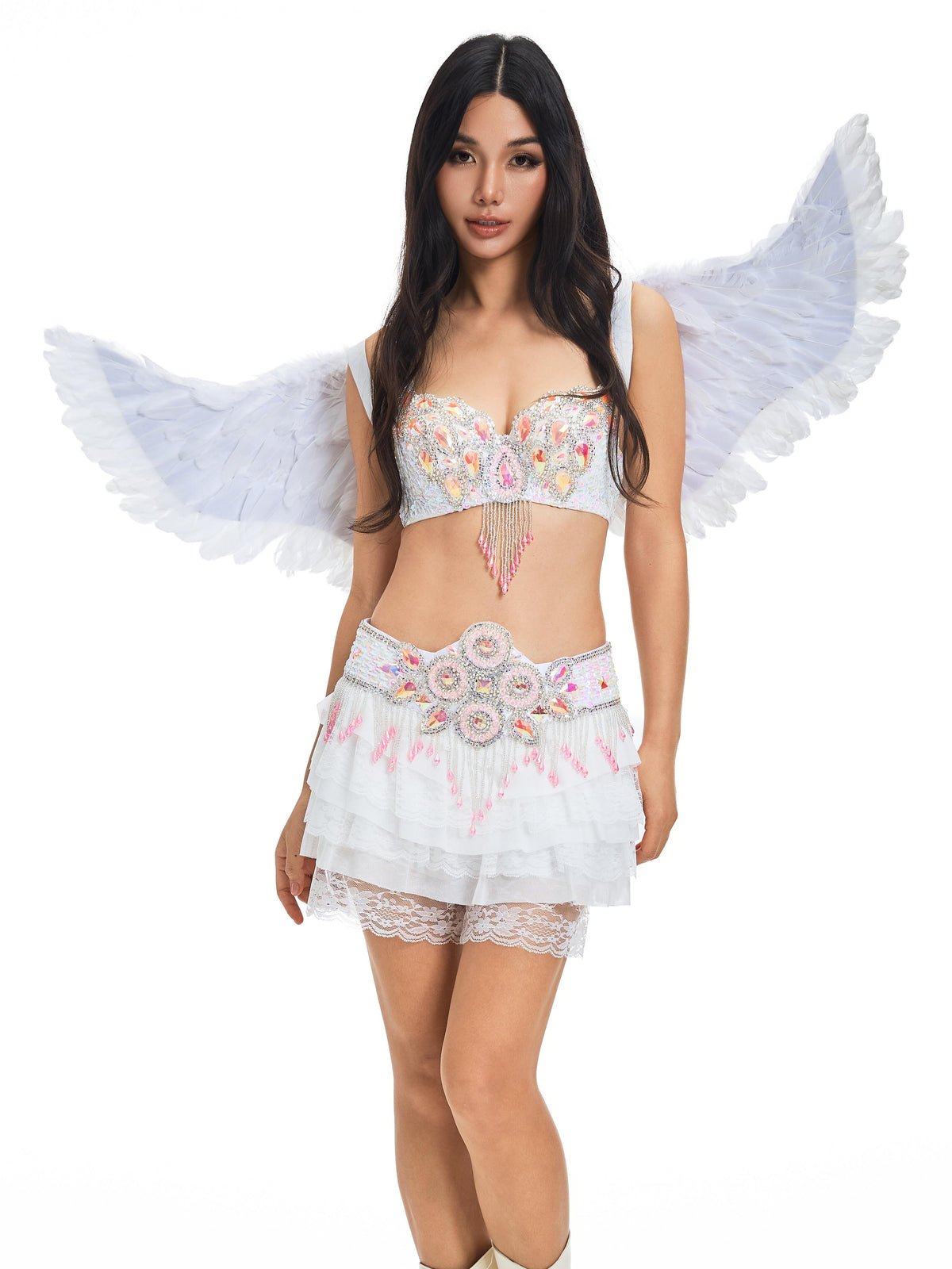 A woman wearing an embellished Halloween costume paired with the Angel Wings- White, featuring a feathered design, a layered skirt, and boots, standing against a plain white background.