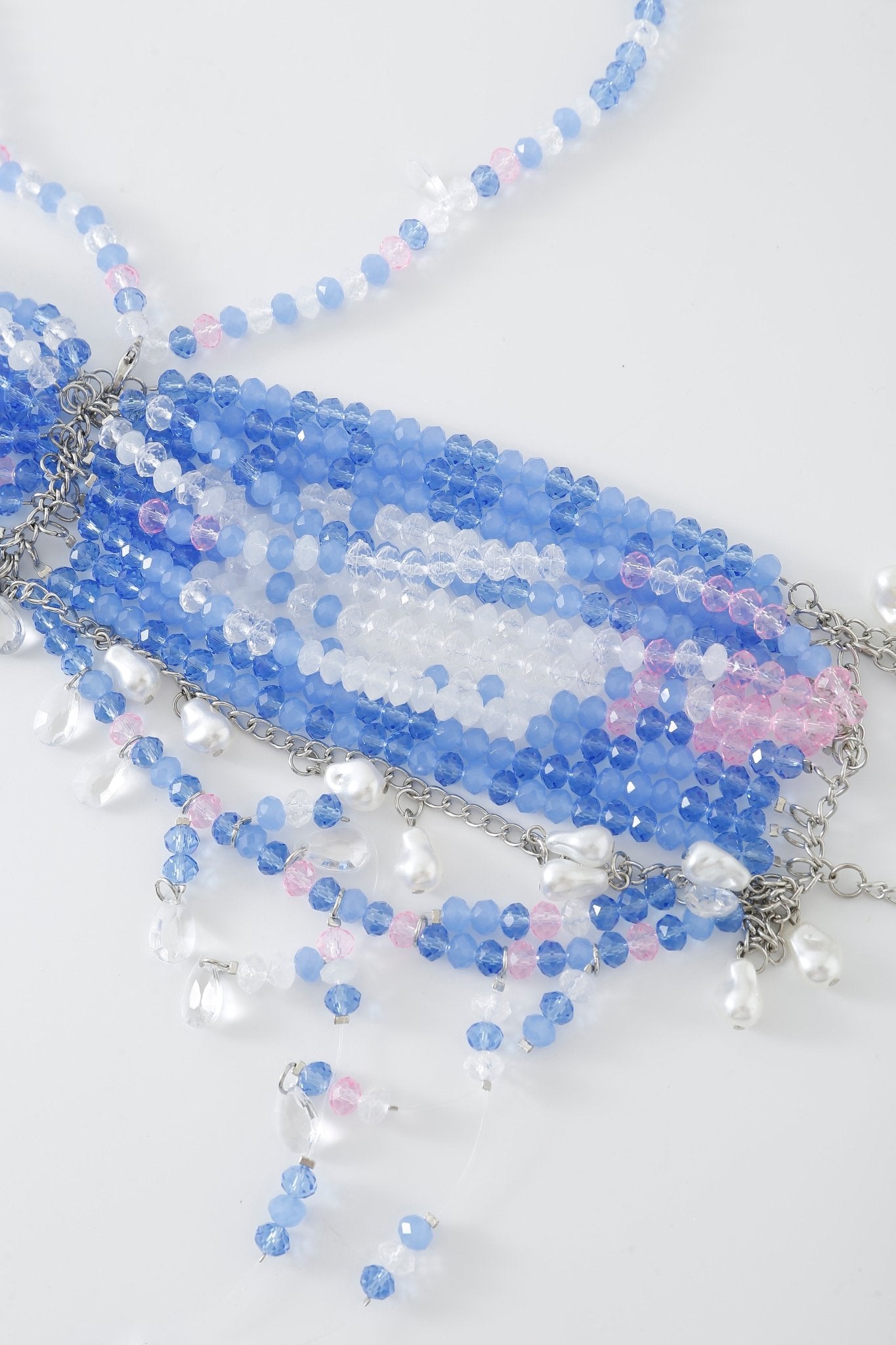Azura w Mini Skirt- Full Set displayed on a white background, featuring a beaded necklace adorned with blue, white, and pink beads complemented by silver chain links and dangling pearl-like accents, reminiscent of the delicate rhinestone detailing often seen in Azura lingerie.