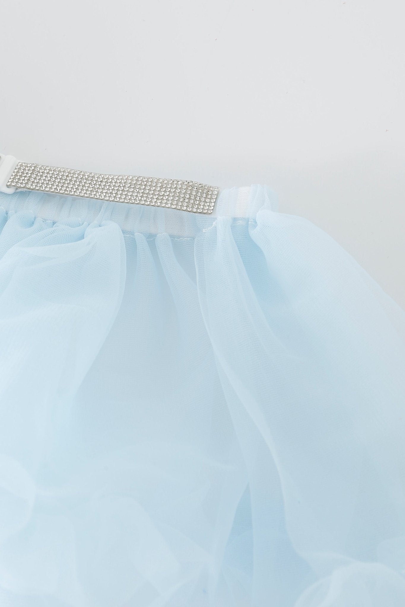 Light blue tulle mesh mini skirt from the Azura w Mini Skirt- Full Set, featuring a white elastic waistband embellished with sparkling rhinestone accents, displayed against a plain white background. Ideal for pairing with Azura lingerie to add a glamorous touch.