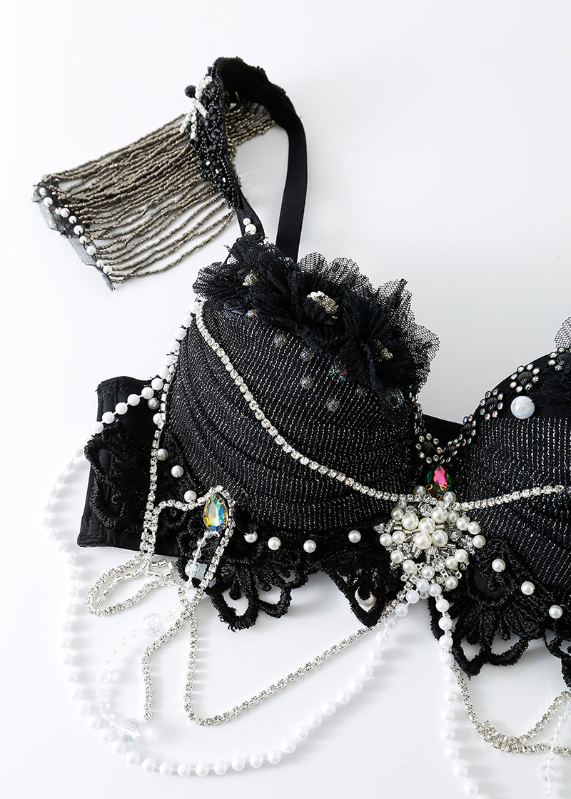 The ECLIPSE - Top is a handmade black rhinestone bra adorned with lace, pearls, and silver chains—ideal as a crystal festival or rave bra top, displayed on a white background.