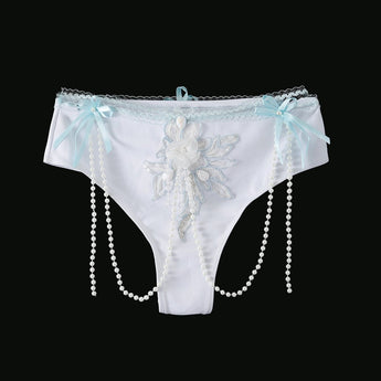 Eira - Full Set - Blue: White lace panties with blue bows, a central floral applique, and pearl bead strands on each side—ideal handcrafted rave festival wear, shown on a black background.