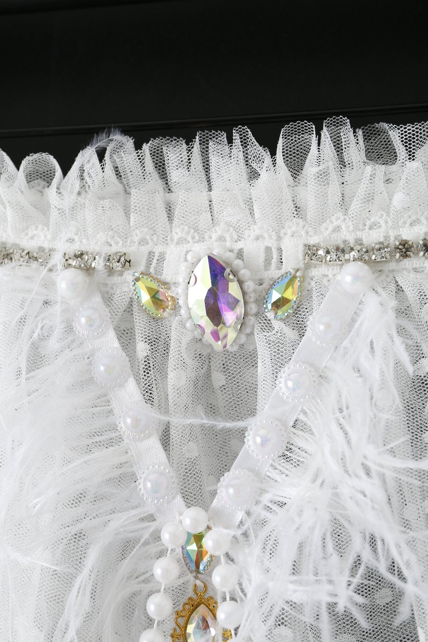 Close-up of the Haló White Skirt adorned with tulle, pearls, rhinestones, and iridescent gems in an ornate pattern—an eye-catching piece perfect for festival outfits.