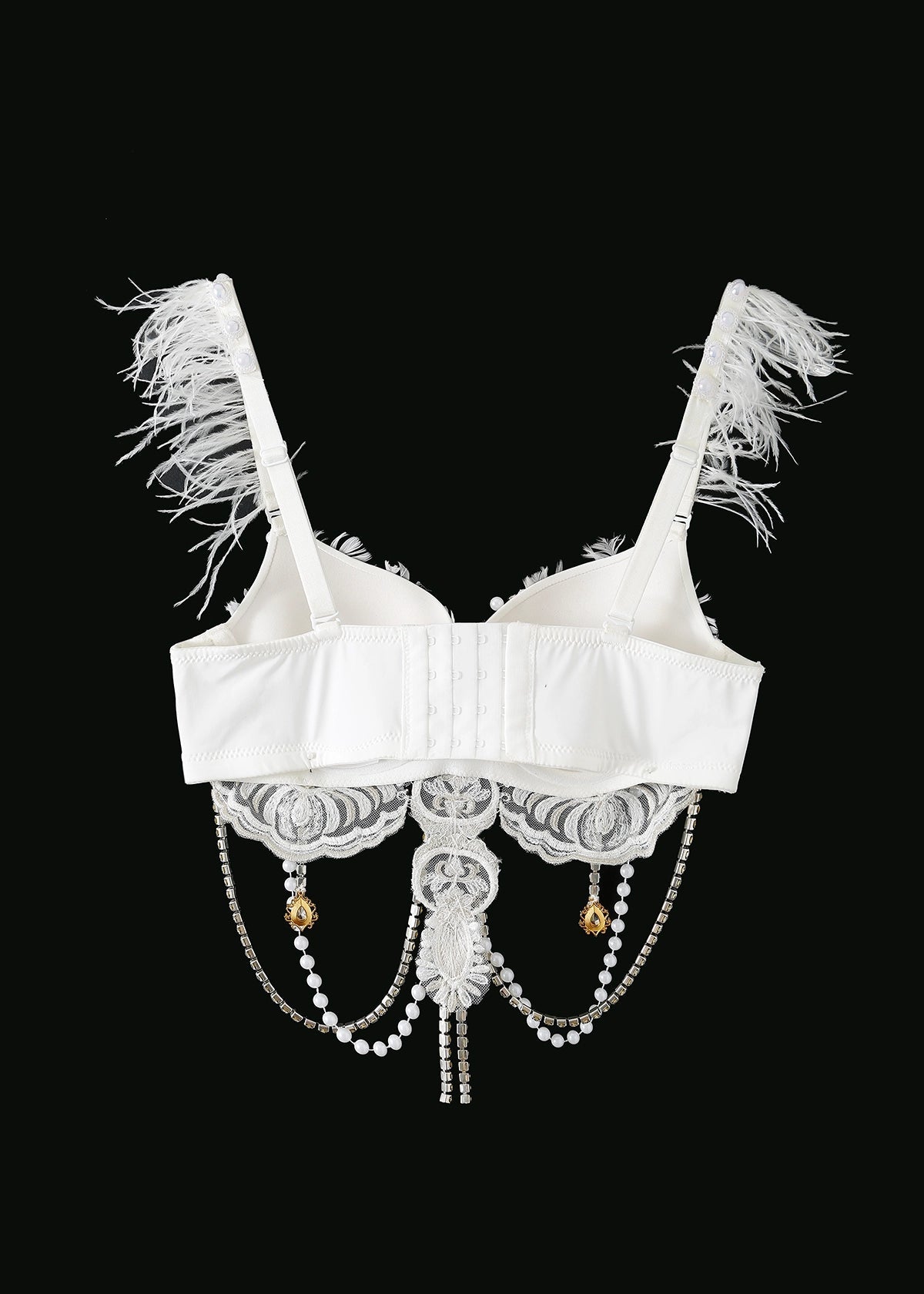 The Haló - White - Top features feathered straps, lace detailing, hand-sewn pearls, and hanging bead and pearl chains—ideal as a striking festival bodysuit accent against a black background.