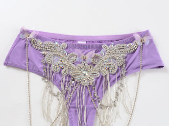 Nocterra - Purple - Bottom features a lavender bikini style with rhinestones, sequins, pearl beads, butterfly accents, and beaded fringe for handmade flair—ideal as a mid-rise cheeky bottom for rave or festival wear.
