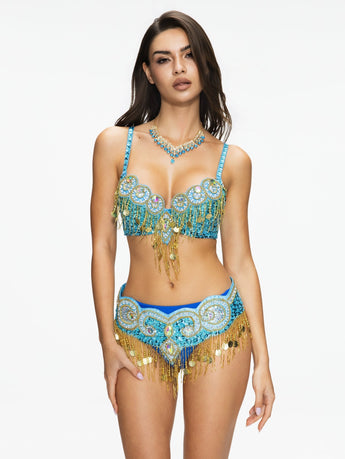 Woman wearing Notics - Aqua - Bottom, a crystal-embellished skirt with fringe and sequins, paired with a blue and gold bra—perfect for festivals or rave wear.