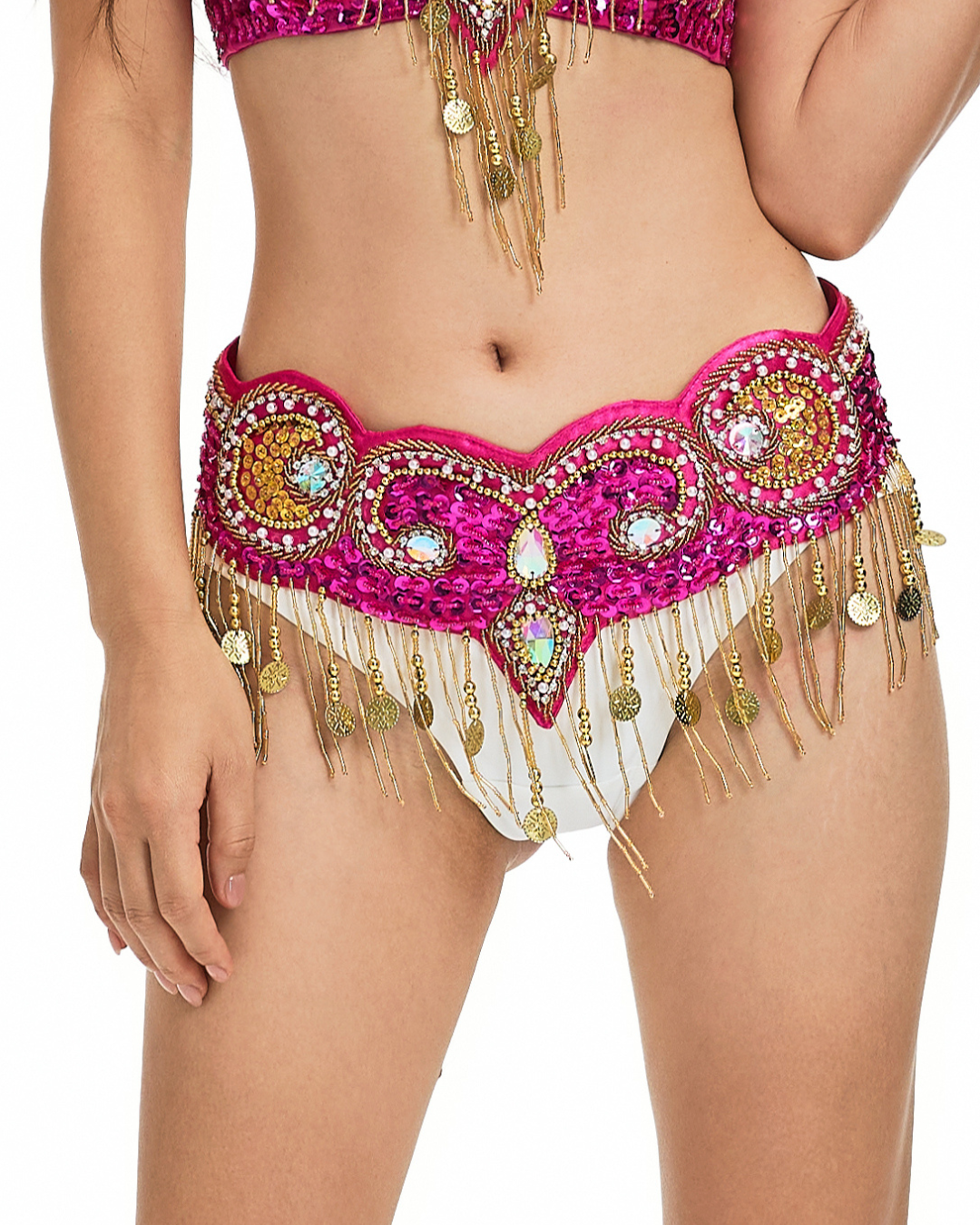 Model wears the Notics-Rosé-Bottom, a pink and gold beaded belly dance costume belt with dangling coins, perfectly paired with a rhinestone bra set, shown from midriff to upper thighs.