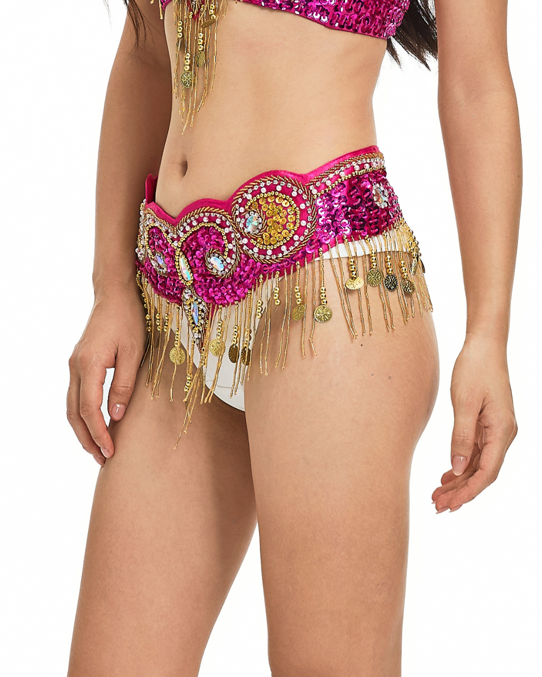 Person wearing the Notics-Rosé-Bottom—a sequined pink and gold belly dance belt with coin fringe—over white bottoms; perfect for rave and festival wear. Only the torso and upper legs are visible.