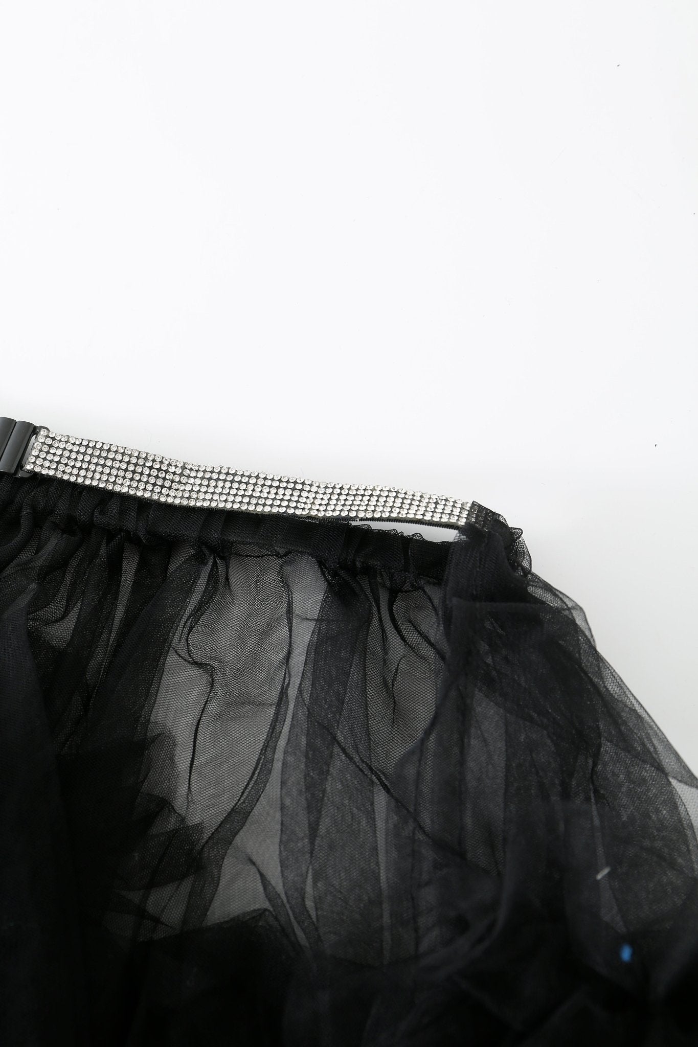 Close-up of the Onyx w Mini Skirt- Full Set in black sheer tulle mesh, featuring a silver rhinestone-studded waistband and elegant rhinestone detailing, photographed on a white background.
