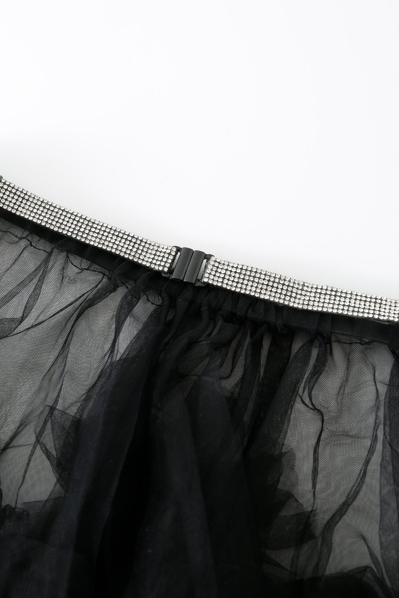 Close-up of the Onyx w Mini Skirt- Full Set, showcasing a black mesh mini skirt paired with a silver rhinestone belt and black metal clasp, featuring elegant rhinestone detailing, photographed on a white background.