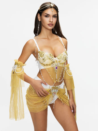 Woman wearing the REVERIE - Full Set - Gold from the Celestial Court Collection, a handcrafted festival outfit featuring sheer fabric, beads, and jewelry, posing against a plain white background.