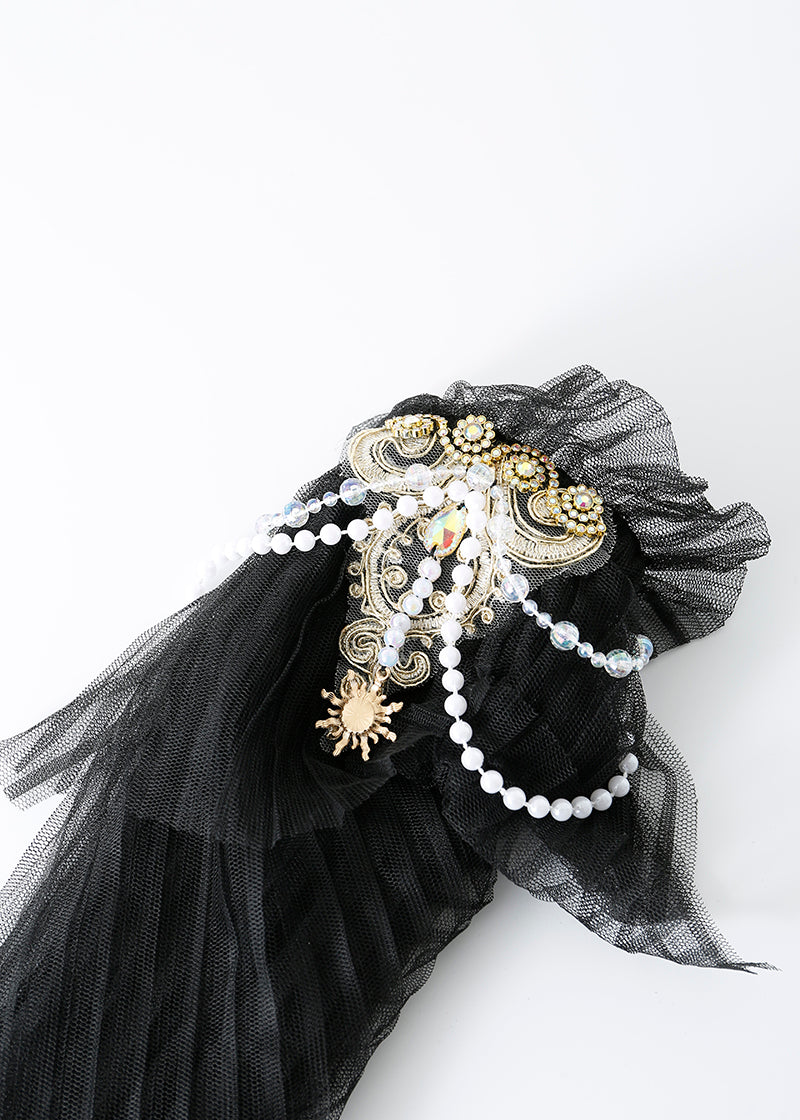 The REVERIE - Full Set - Black features black mesh fabric, gold and silver details, pearls, and a sun-shaped charm—ideal for adding elegance to any handcrafted rave wear or festival costume.