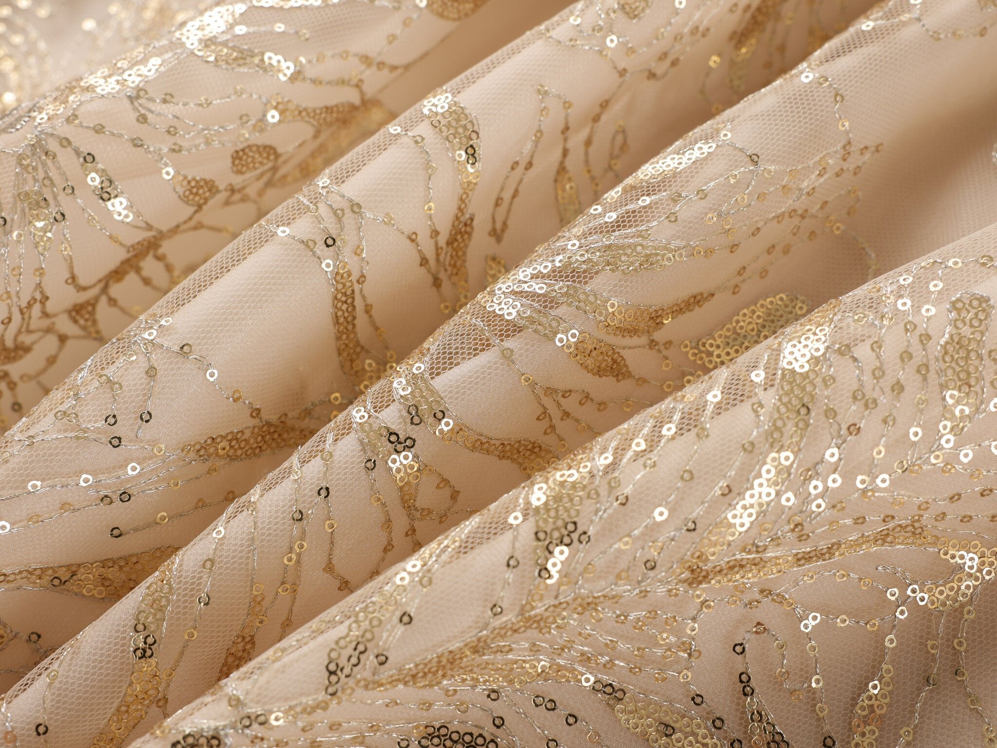 Close-up of the Selene-Full Set-Gold: beige mesh fabric adorned with gold sequin embroidery in an abstract floral pattern—perfect for elevating a rhinestone fringe set or bringing an elegant touch to your next festival outfit.